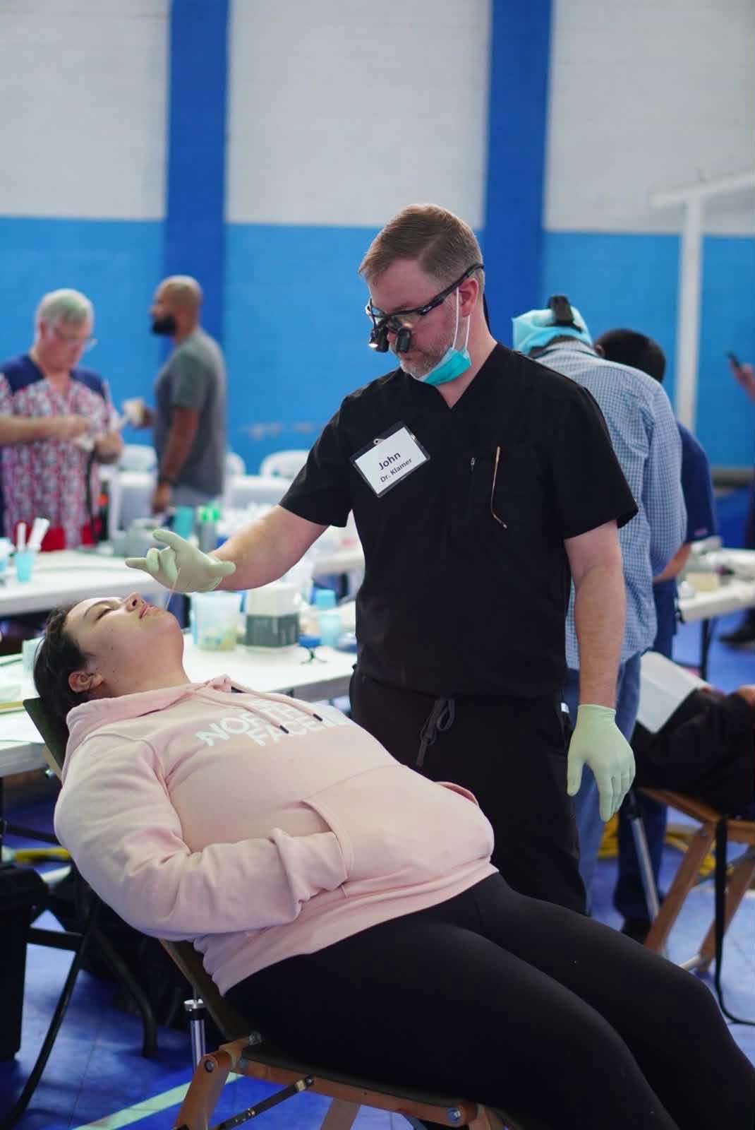 Dr. Klamer providing dental care at a community event