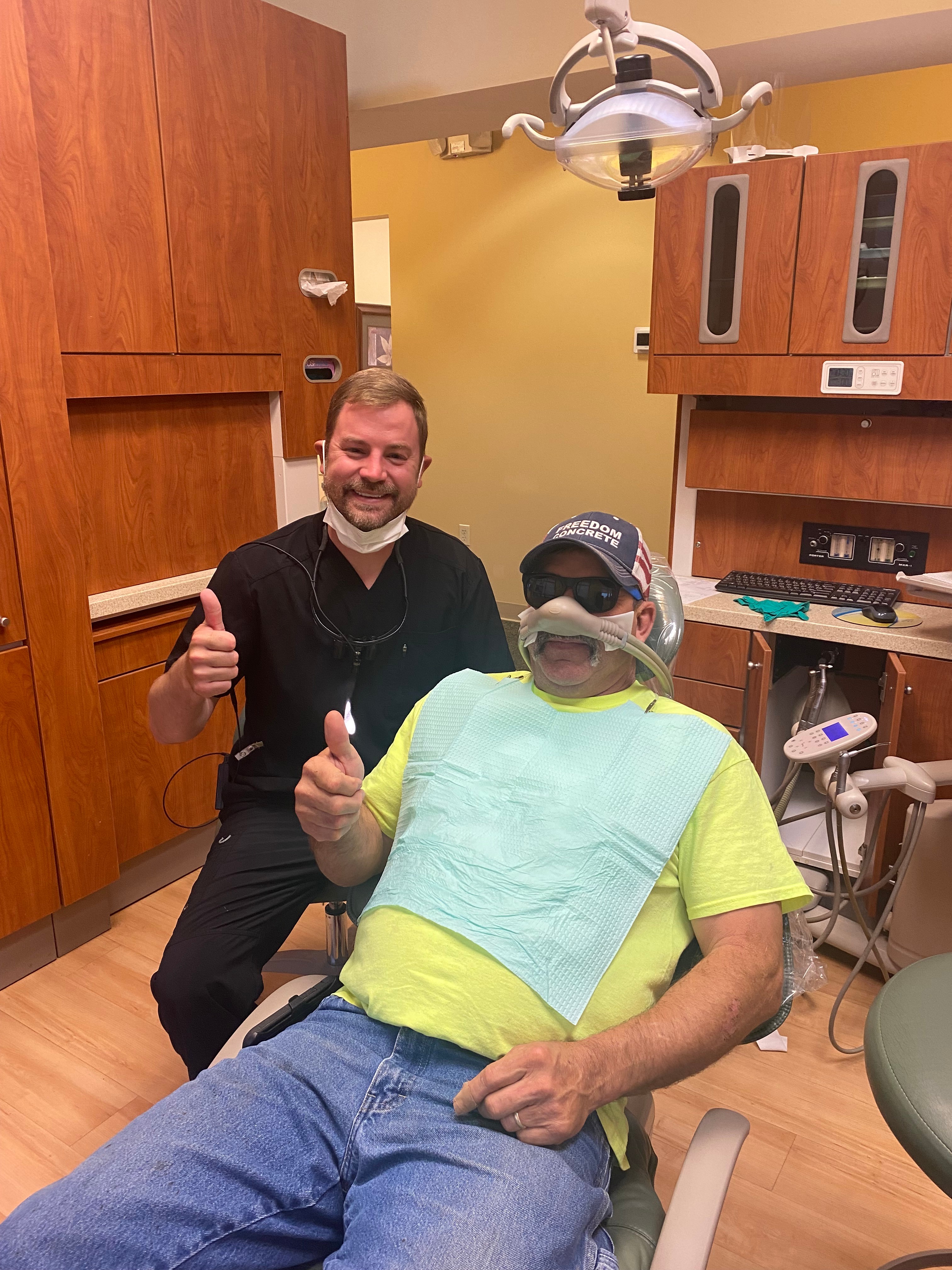 Dr. Klamer and a smiling patient giving thumbs up after treatment